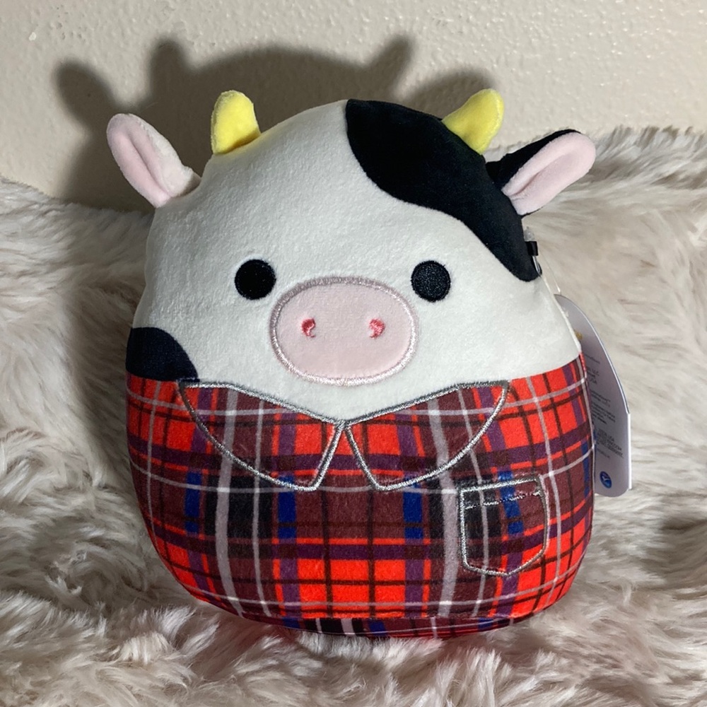 Connor the Cow Squishmallow wearing a flannel shirt